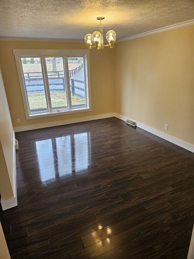 unfurnished room featuring an inviting chandelier, crown molding, dark hardwood / wood-style floors, and a textured ceiling