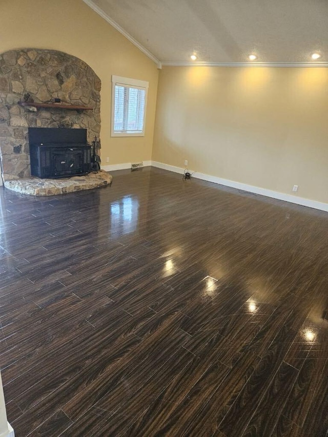 unfurnished living room with lofted ceiling, dark hardwood / wood-style flooring, a fireplace, and ornamental molding