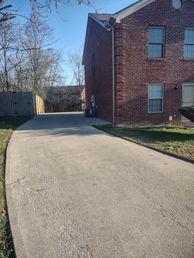 view of side of home with central air condition unit