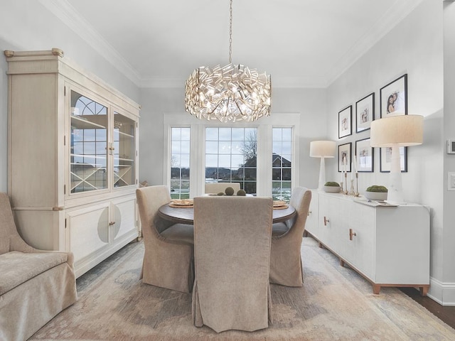 dining space featuring crown molding, a healthy amount of sunlight, and a chandelier