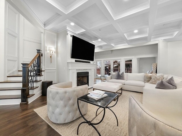 living room with beamed ceiling, ornamental molding, coffered ceiling, and hardwood / wood-style floors