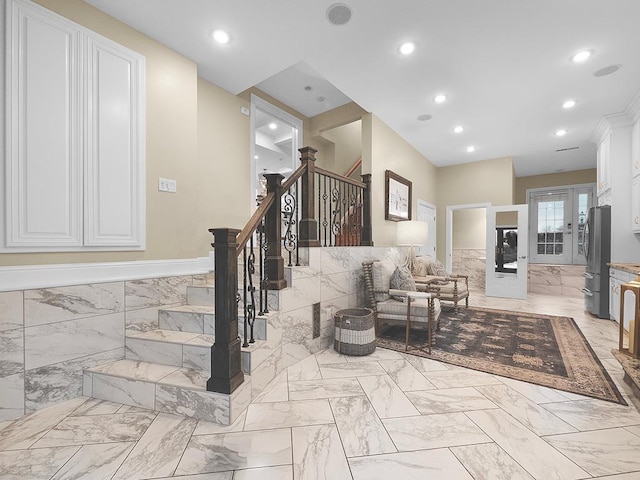 living room with tile walls and french doors