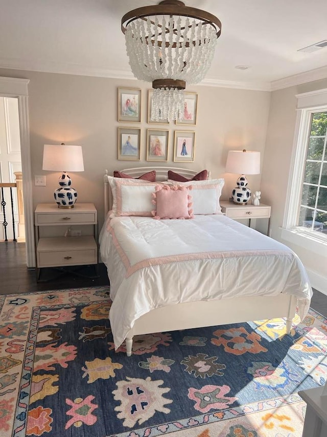 bedroom with ornamental molding, dark hardwood / wood-style floors, and a chandelier