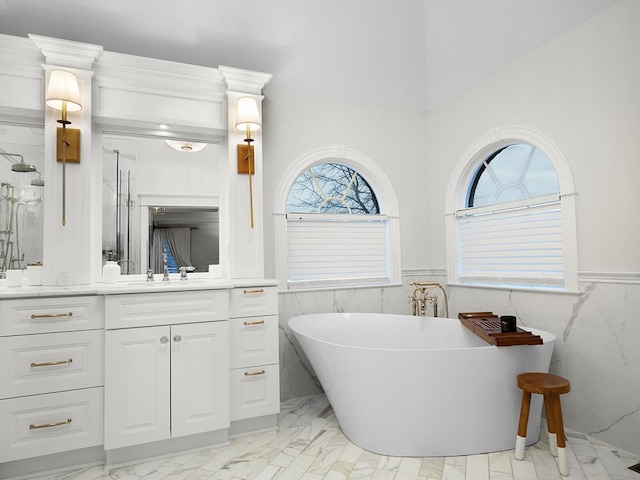 bathroom featuring vanity and a tub to relax in