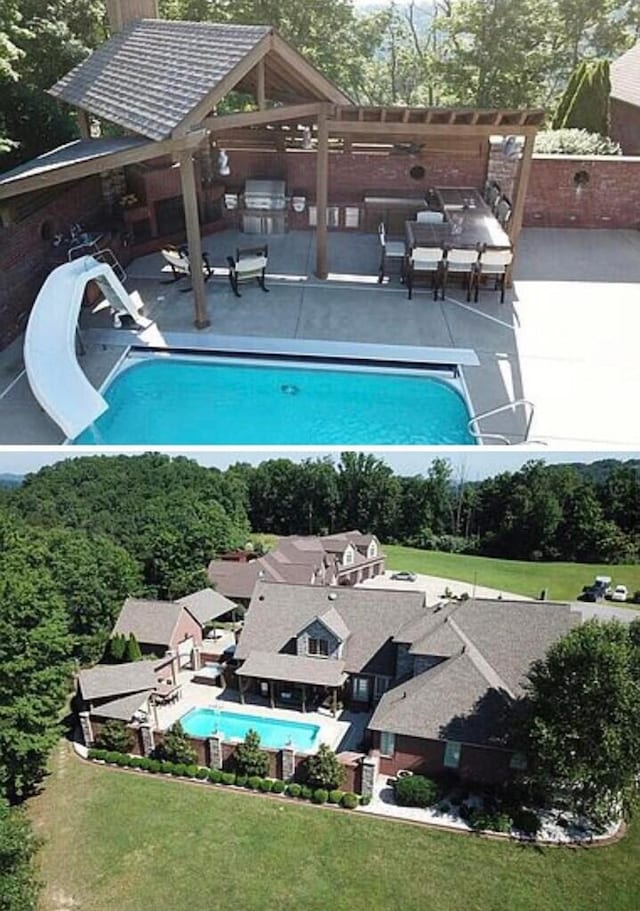 view of pool with a patio, a water slide, a diving board, and an outdoor kitchen