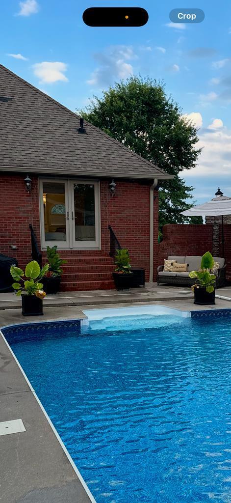 view of swimming pool featuring french doors