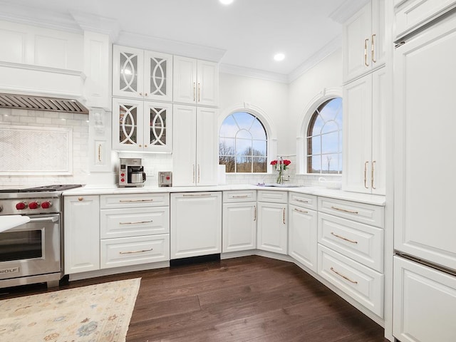 kitchen featuring white cabinetry, sink, decorative backsplash, stainless steel range, and crown molding