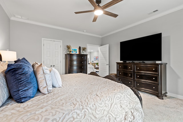 bedroom featuring ornamental molding, light colored carpet, ceiling fan, and a closet