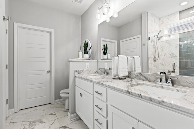 bathroom with walk in shower, vanity, and toilet