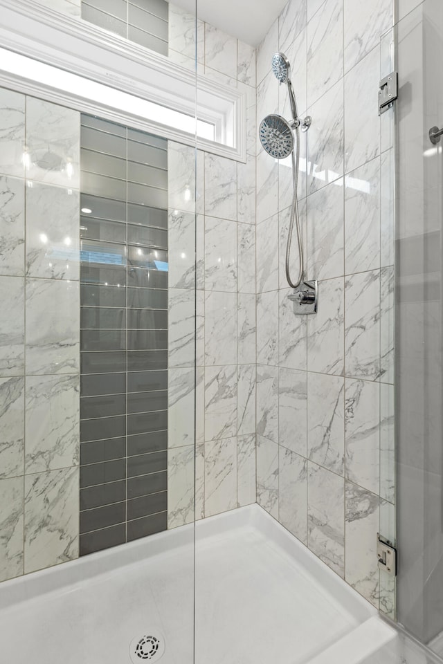 bathroom with a tile shower