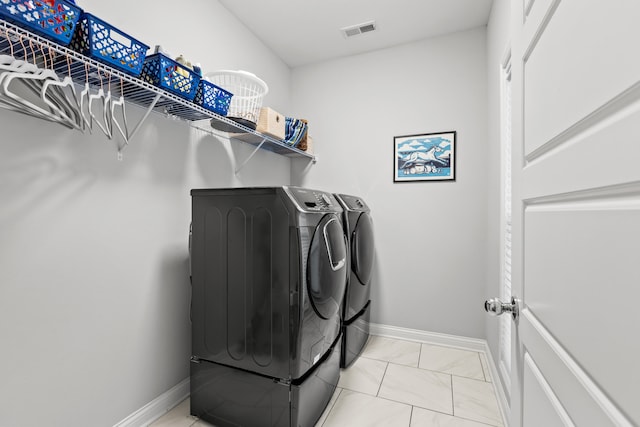 clothes washing area with separate washer and dryer