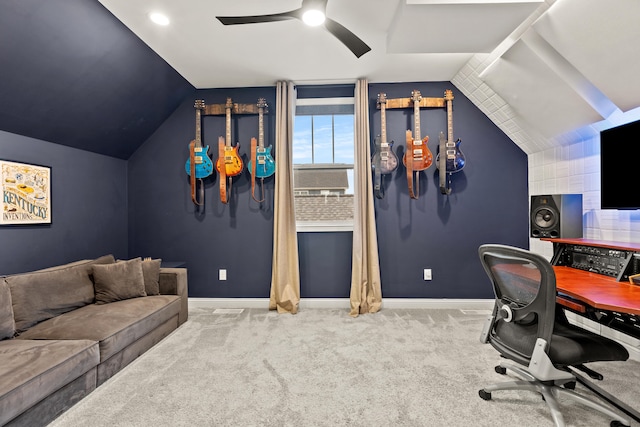 carpeted office with lofted ceiling and ceiling fan