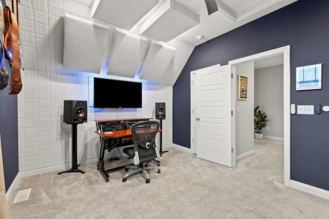 carpeted office space featuring lofted ceiling