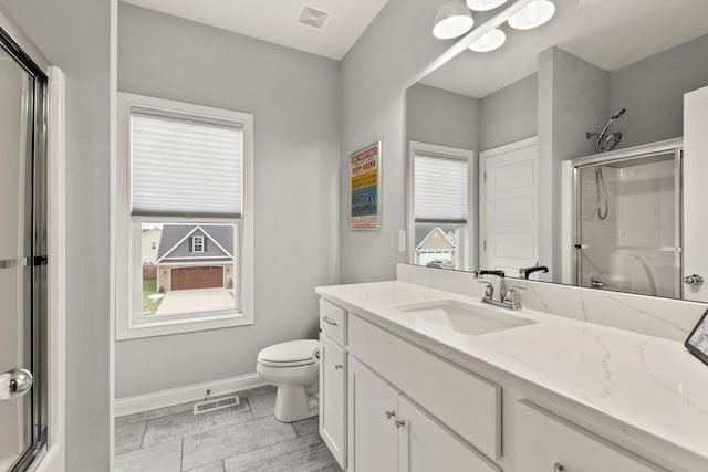 bathroom featuring walk in shower, vanity, and toilet