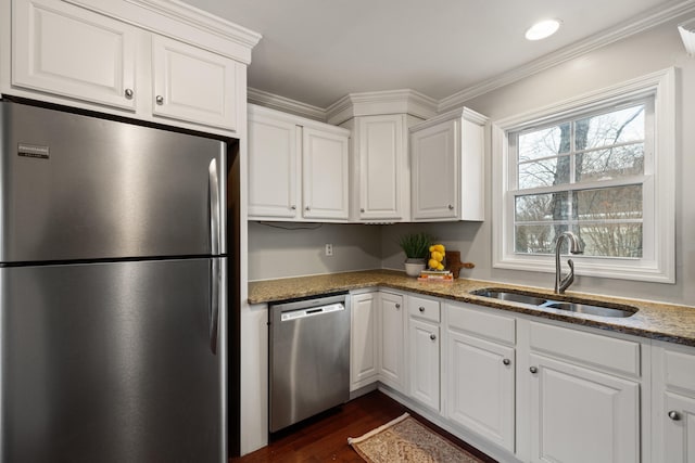 kitchen featuring stone counters, appliances with stainless steel finishes, sink, and white cabinets