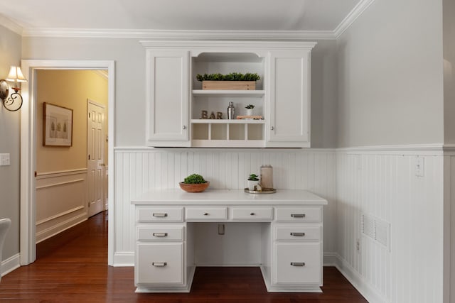 unfurnished office featuring dark hardwood / wood-style flooring and ornamental molding