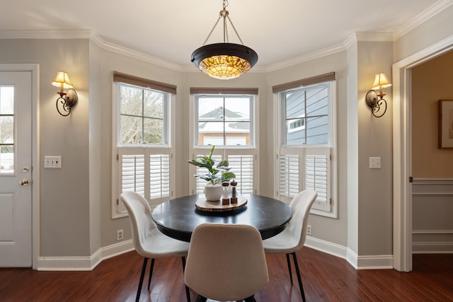 dining room with ornamental molding and dark hardwood / wood-style flooring