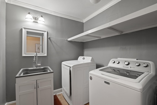 washroom featuring crown molding, separate washer and dryer, and sink