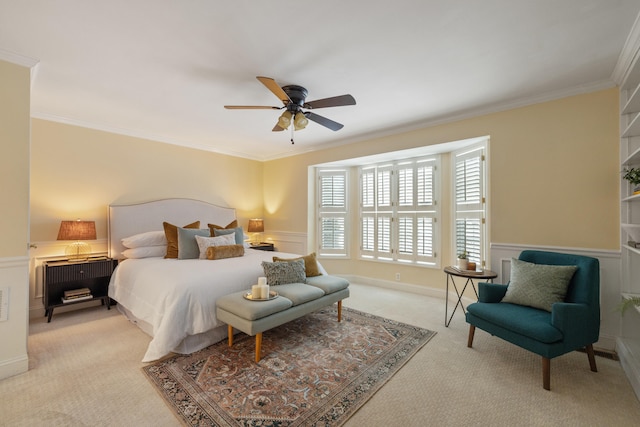 carpeted bedroom featuring ornamental molding and ceiling fan