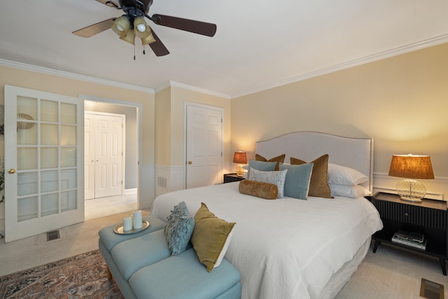 bedroom with crown molding, light colored carpet, and ceiling fan