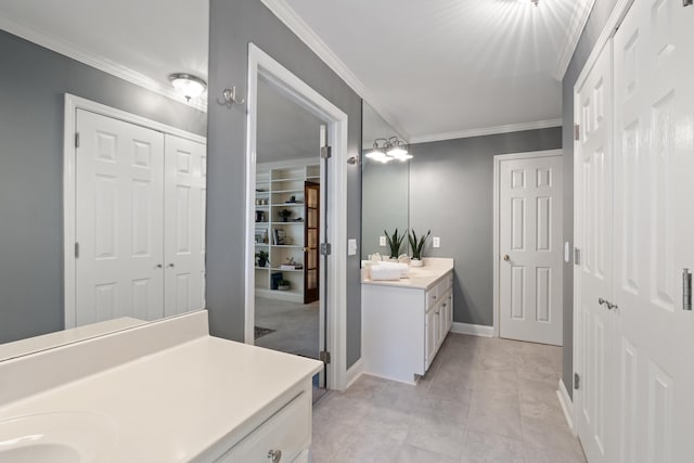 bathroom featuring crown molding and vanity