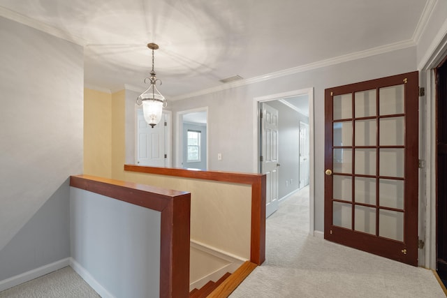 hall featuring crown molding and light colored carpet