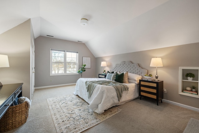 carpeted bedroom with lofted ceiling