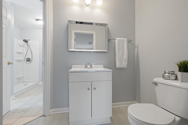 bathroom with vanity, toilet, and a shower