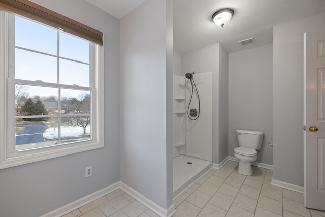 bathroom featuring toilet and a shower