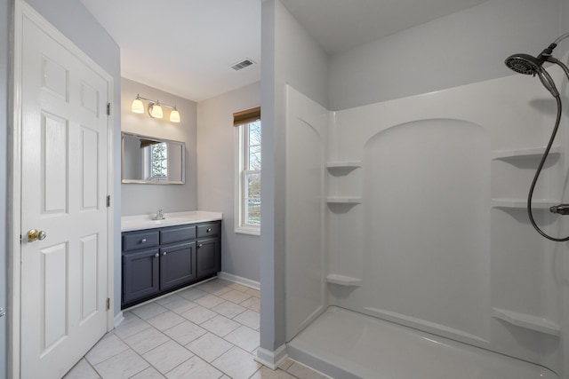 bathroom with walk in shower and vanity