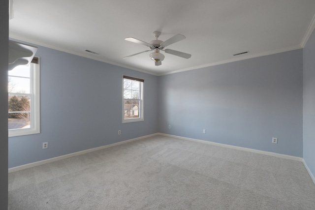 unfurnished room with ceiling fan, light colored carpet, and ornamental molding