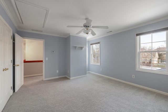 carpeted empty room with crown molding and ceiling fan