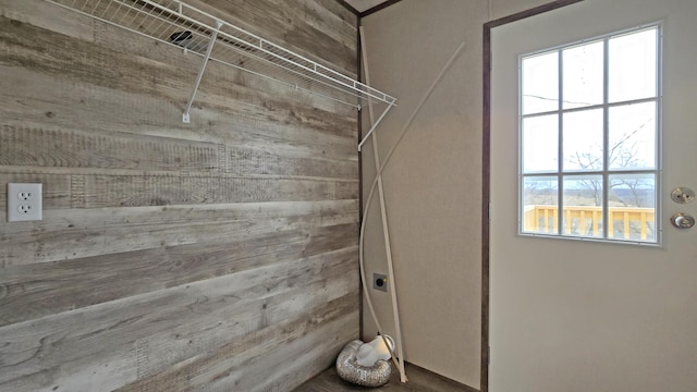 laundry room featuring wooden walls and electric dryer hookup