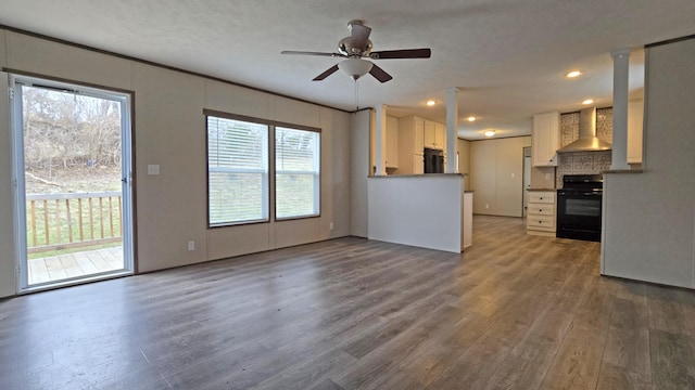 unfurnished living room featuring wood-type flooring and ceiling fan