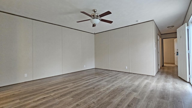 spare room featuring ceiling fan and light hardwood / wood-style flooring