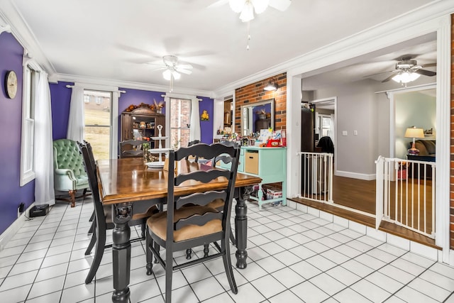 tiled dining space featuring crown molding and ceiling fan