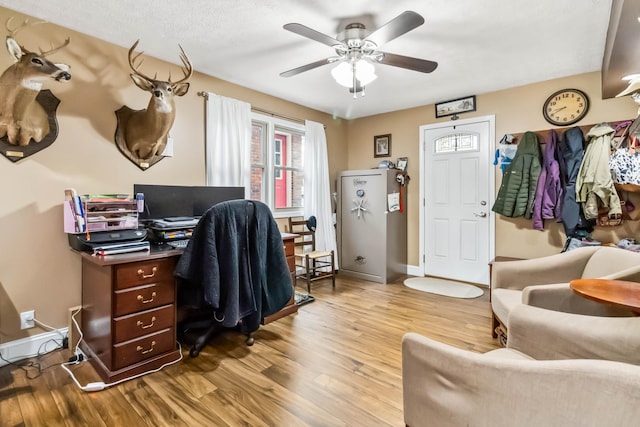 home office featuring ceiling fan and light wood-type flooring