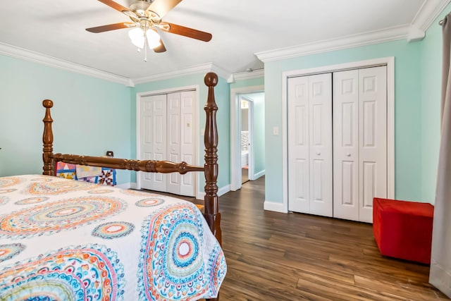 bedroom featuring multiple closets, ornamental molding, ceiling fan, and dark hardwood / wood-style flooring