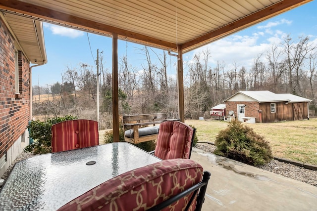 view of patio with an outbuilding