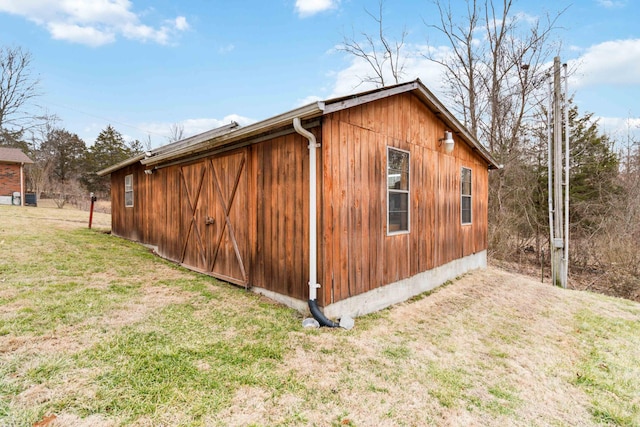 view of side of home with a lawn