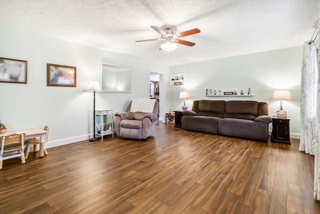 living room with ceiling fan, hardwood / wood-style floors, and a textured ceiling