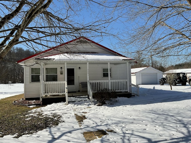 view of front of home with a garage, an outbuilding, and covered porch