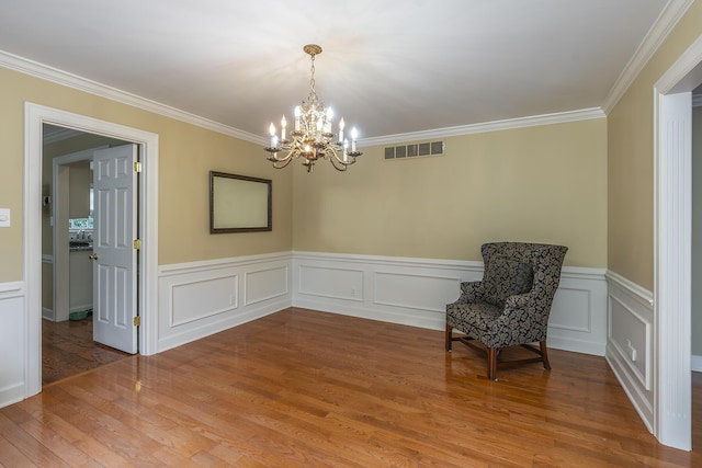 unfurnished room with crown molding, hardwood / wood-style flooring, and a chandelier