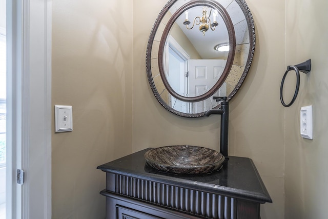 interior details featuring vanity and a notable chandelier