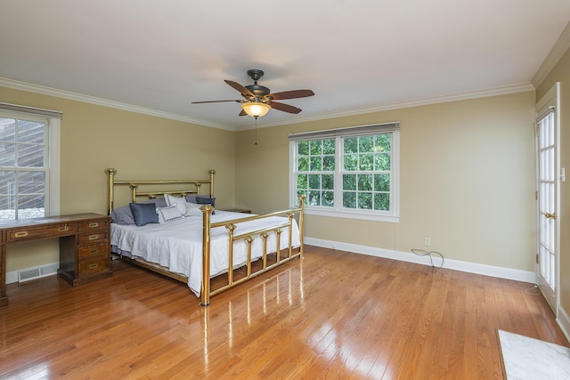 bedroom featuring ceiling fan, ornamental molding, and light hardwood / wood-style floors