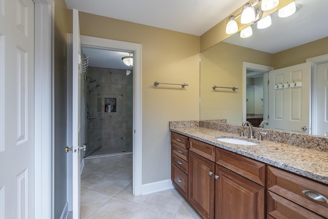 bathroom featuring vanity, tile patterned floors, and walk in shower