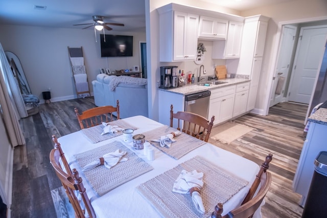 dining room featuring ceiling fan, sink, and dark hardwood / wood-style floors