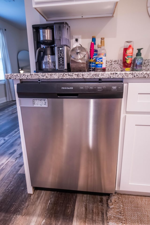 details with dark wood-type flooring, dishwasher, light stone counters, and white cabinets