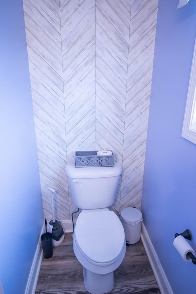 bathroom with hardwood / wood-style floors and toilet