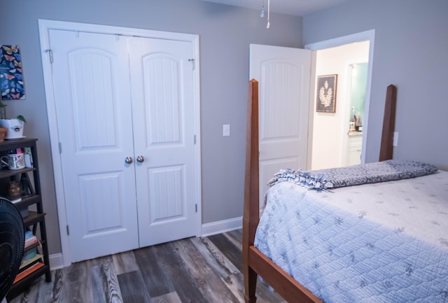 bedroom with a closet and dark hardwood / wood-style floors